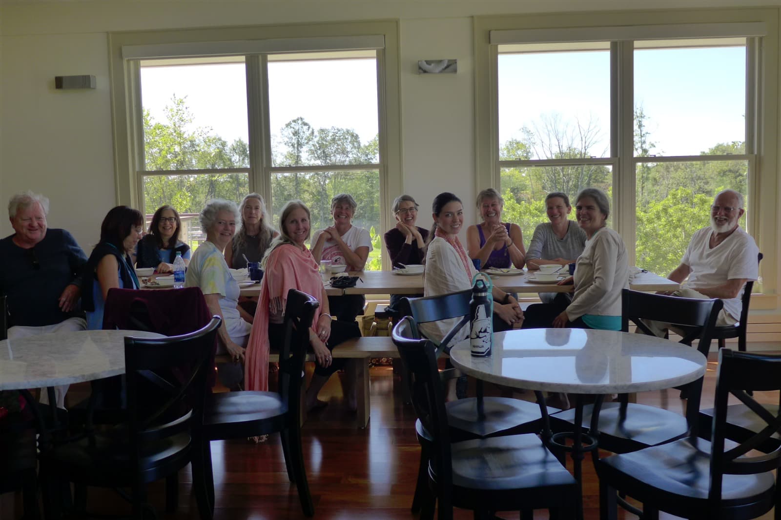 A group around a table turn to look at the camera