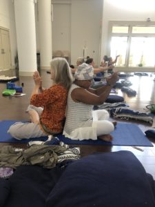 Two women doing yoga back to back