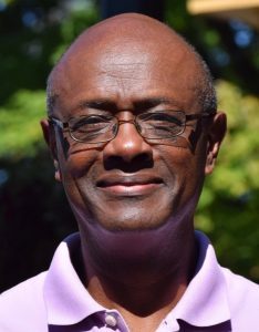 smiling man in a lavendar shirt