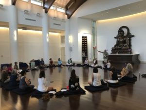 People sittign in a circel during a yoga retreat