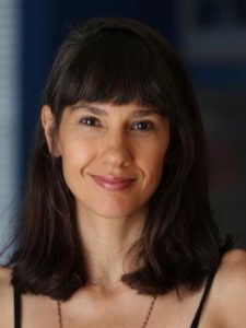 Smiling woman with dark hair and bangs