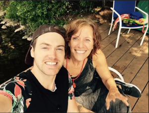 a man and woman on a patio, smiling up at the camera