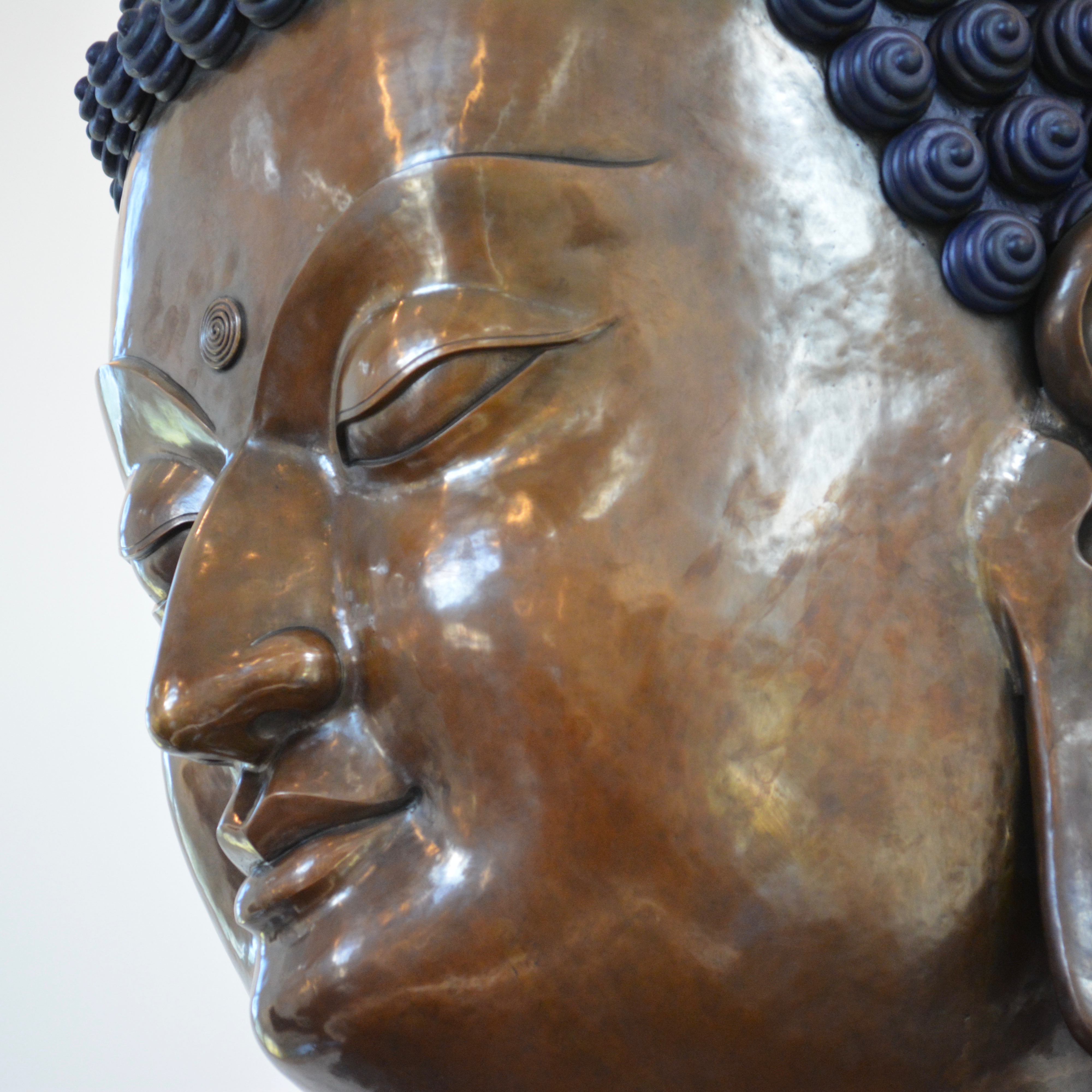 Closeup of the face of a copper Buddha