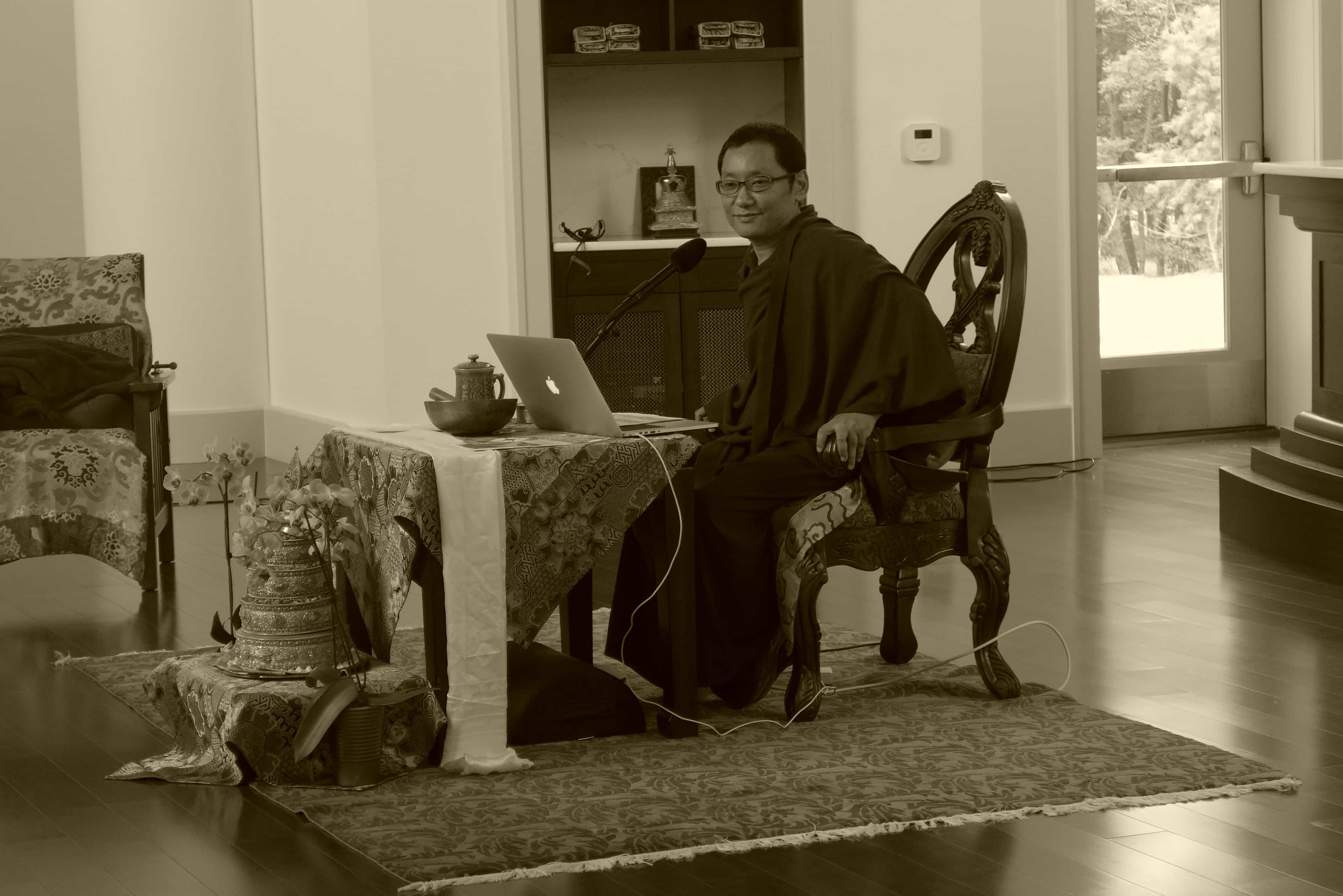 Black and White picture of seated Tibetan monk