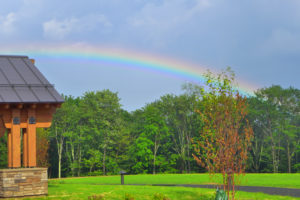 a rainbow with a building int he foreground