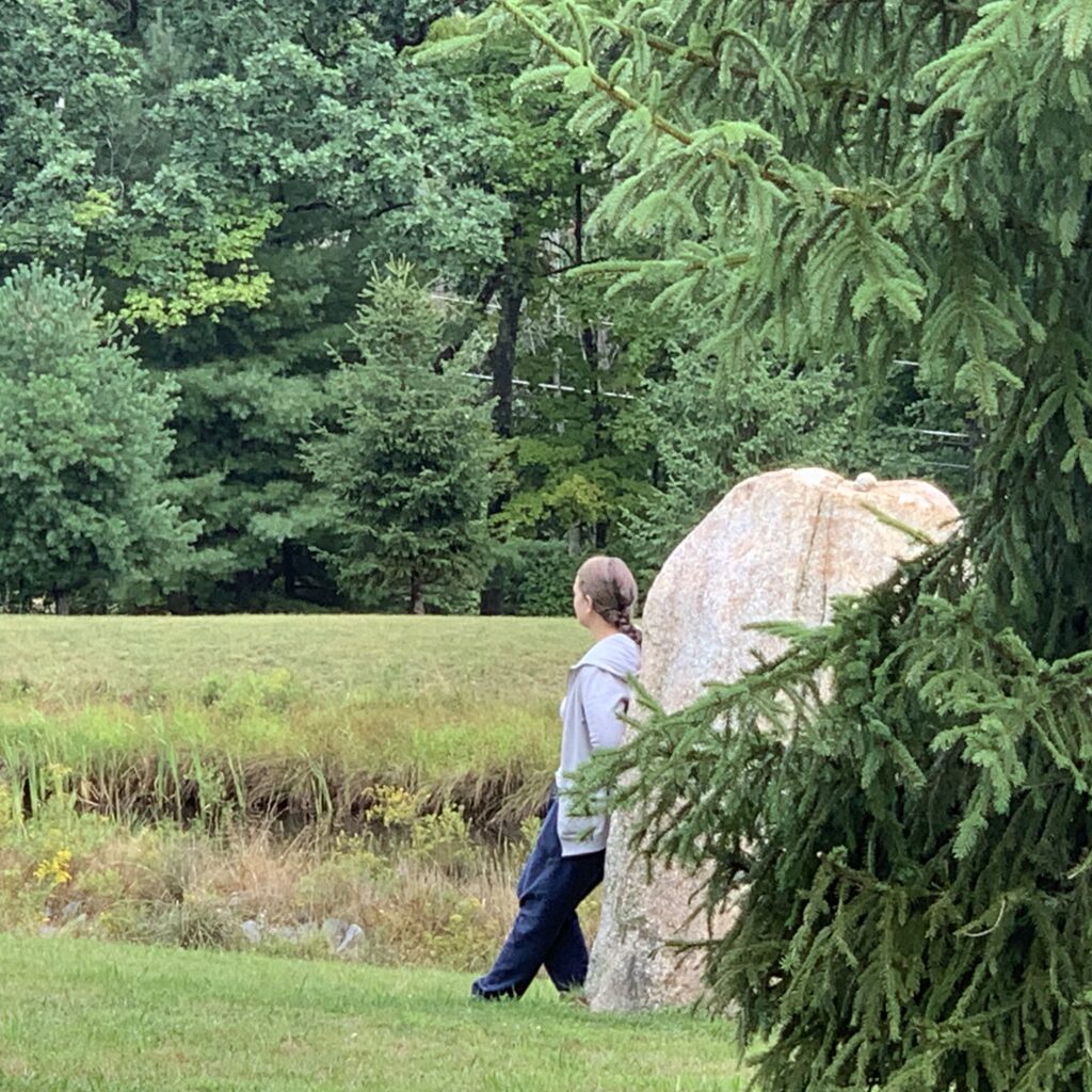 Woman leans against a rock in contemplation