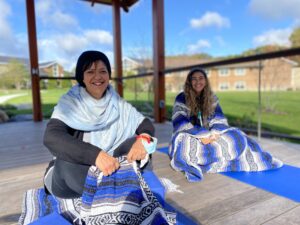 Two women doing outdoor yoga