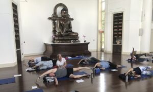 People practicing somatic yoga