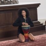 woman playing the bongo drums