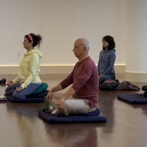 three people meditating